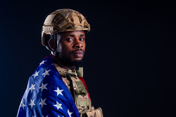 military army african male camouflage suit sorrow wrapped in an American flag black background...