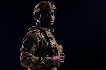 Fototapeta premium military army african male camouflage suit sorrow black background studio