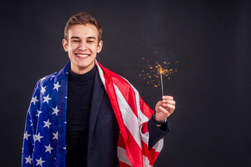 model holding bengal light wrapped in American flag black background studio