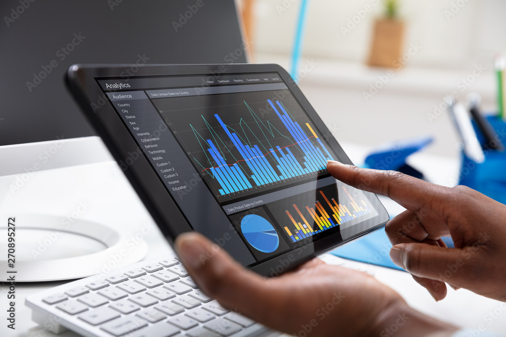 Poster person's hand pointing on graph at tablet