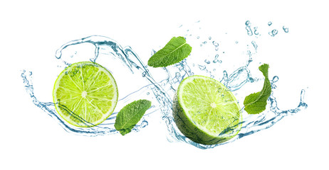 Slices of juicy lime, fresh mint and splashing cold water on white background