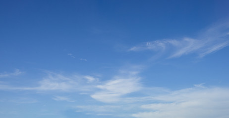 Faint clouds in a bright blue sky