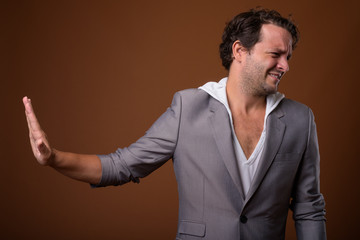 Studio shot of Italian businessman against brown background