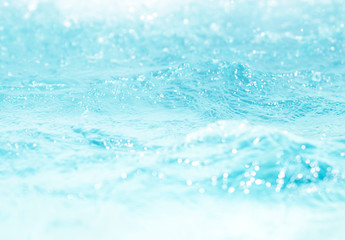 Blurred water, glittering bokeh abstract; background nature