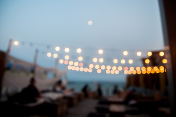 Blur mode of restaurant near the sea in evening time with bokeh background 