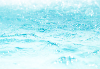 Blurred water, glittering bokeh abstract; background nature