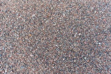 Sea pebble texture. Small multicolored pebble-stones. Close up beach stones surface.
