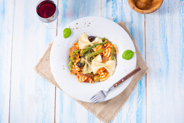 colorful farfalle with green asparagus olives and parma ham