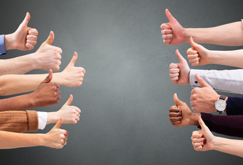 People Hand Showing Thumb Up Sign Against Green Backdrop
