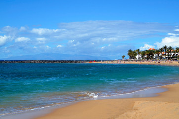 Fototapeta na wymiar View of Playa del Camison beach with turquoise water and yellow sand in Las Americas, Tenerife,Canary Islands,Spain.Summer vacation or travel concept.