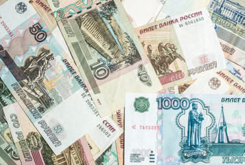 Money. Russian rubles. Notes in denominations of five, ten, fifty, one hundred, five hundred and a thousand rubles. Cash. Background texture.