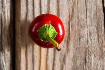cherry pepper on old wood table, top view