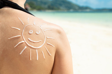 Sun Drawn With Sunscreen Lotion On Woman's Back