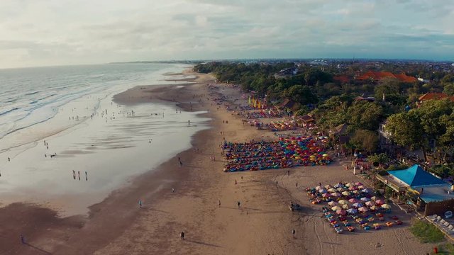  Aerial view of the beach with multicolored umbrellas and decks
