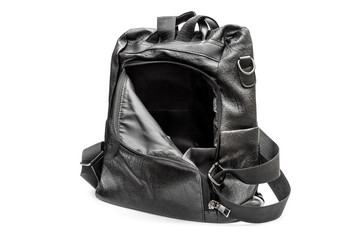 Opened black leather backpack on white background.