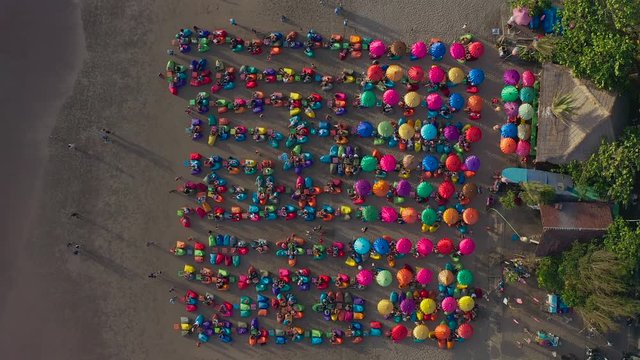  Aerial view of the beach with multicolored umbrellas and decks