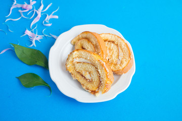 Sweet classic biscuit roll with peony on a blue background. Tomorrow for a girl