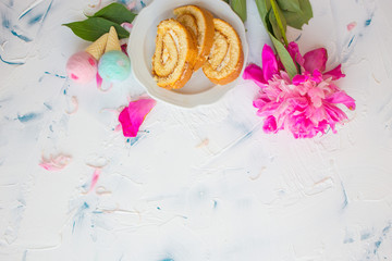 Sweet cake on a white background with pink peony. Romantic breakfast. Woman's desk at work