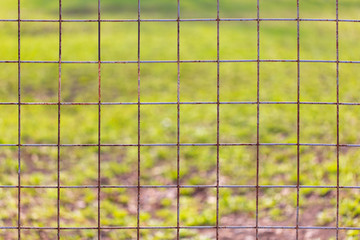 Rusty metal grid on the fence as a background