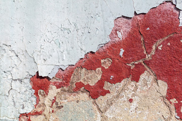 Concrete wall with cracked paint as abstract background