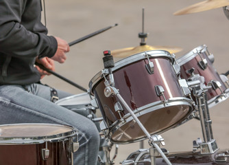 Man playing drums at a concert in the park