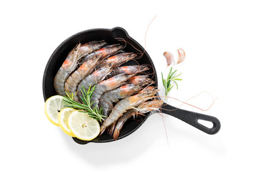 Raw  fresh  prawns (shrimps) with lemon and fresh herbs isolated on white background.