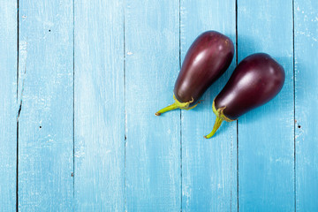 two eggplants on blue wood table