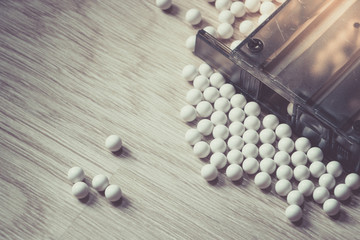Ammunition with BB metallic balls and magazine on wood background.