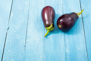 two eggplants on blue wood table