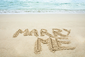 Marry Me Written On Sand Near The Coast