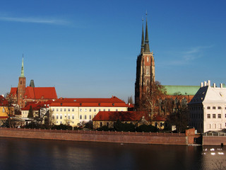 Scenic view of the historic part of Wroclaw through the expanse of water. Image with bright sun