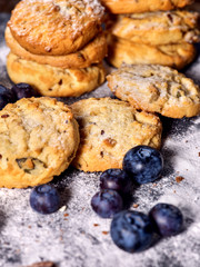 Bakers gonna bake. Serving food on slate. Oatmeal cookies biscuit with blueberry on dark tiles countrylike. Chocolate chip cookies shop on window display. Perfect product.