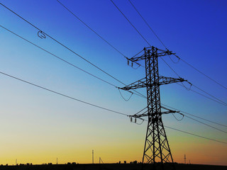 high voltage power transmission line at sunset