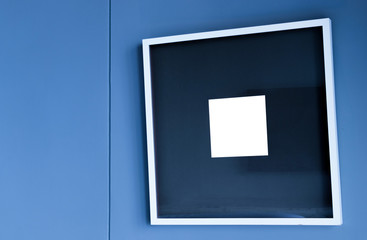 Black and White blank frame on a wall blue background design.