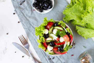 Appetizing greek salad in a plate on a served table