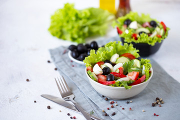 Appetizing greek salad in a plate on a served table