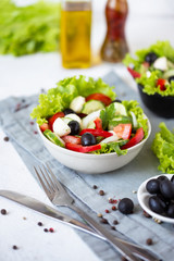 Appetizing greek salad in a plate on a served table