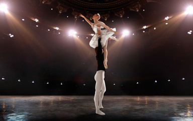 Ballet. Classical ballet performed by a couple of ballet dancers on the stage of the opera house.