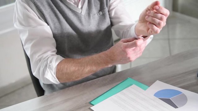 Businessman rolling up his sleeves