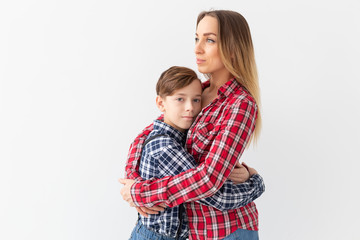Mothers day, children and family concept - Beautiful woman and her son on white background