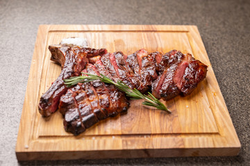 Food and horse meat concept - Roast meat on cutting board with cumin