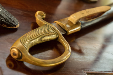 cavalry saber golden handle hilt on the wooden table officer warrior cavalryman