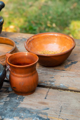 Naklejka premium clay dishware jug plate traditional rustic utensils european on a wooden table