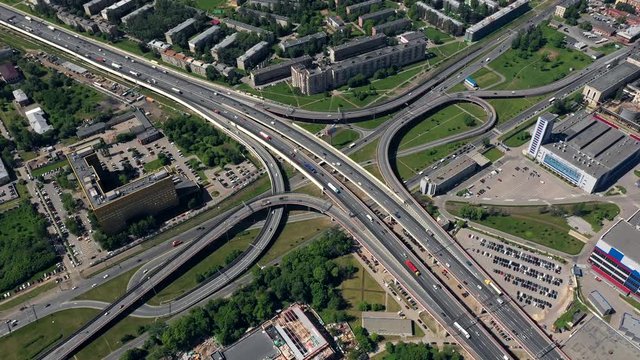 AERIAL. Amazing topview of two-level road junction in Russia. Day traffic of expressways. Saint - Petersburg