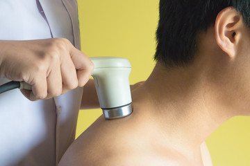 Physicaltherapist using ultrasound probe on patient shoulder for release pain.
