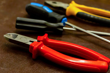 tools working and the engineer close-up. Screwdriver mites red rubber repair electronic equipment