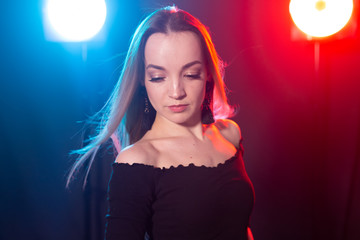 Portrait of young sexy woman with flashes on background