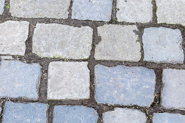 gray stone pattern row of cobblestones dark cement stripes hard weathered urban style