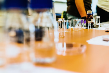 Valencia, Spain - May 25, 2019: Science teachers in a classroom showing experiments to their students in test tubes.