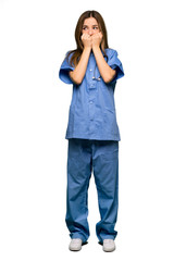 Full body Young nurse is a little bit nervous and scared putting hands to mouth on isolated background